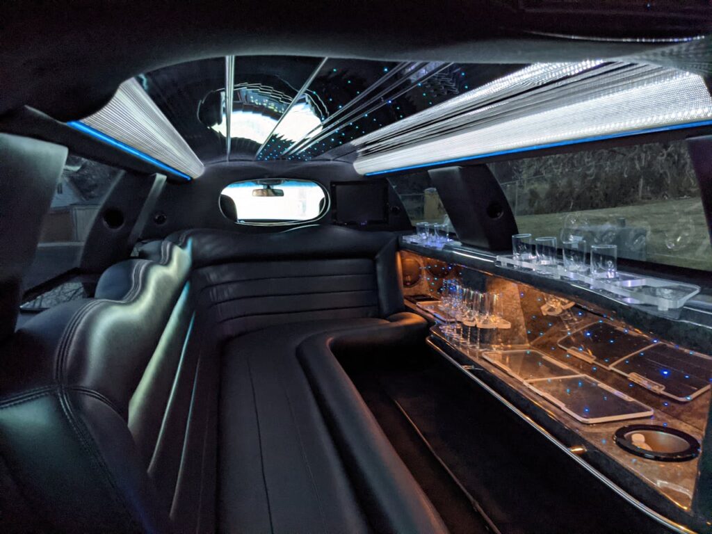 Luxury party bus and stretch limousine interior with LED lighting and bar, Los Angeles